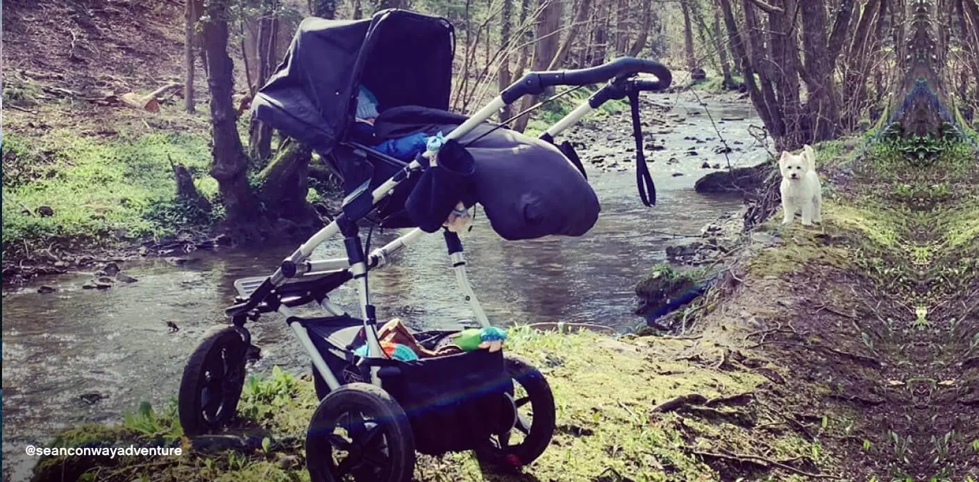 Mountain Buggy urban jungle pram with carrycot – parent facing position beside woodland stream