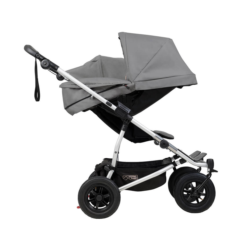 Mountain-Buggy-duet-buggy-with-single-silver-carrycot-plus-in-parent-facing-mode-side-view.webp