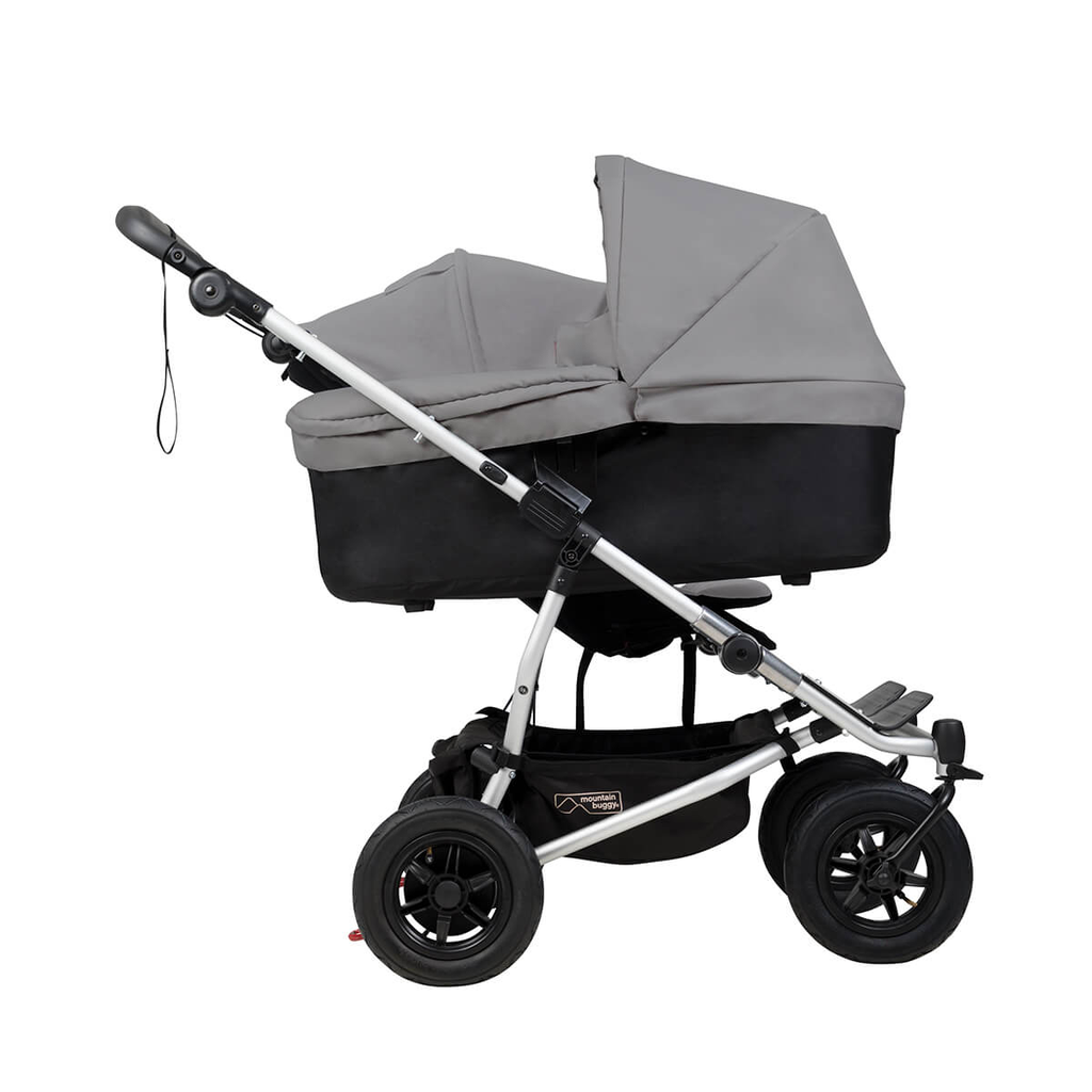 Mountain-Buggy-duet-buggy-with-single-silver-carrycot-plus-in-lie-flat-mode-side-view.webp