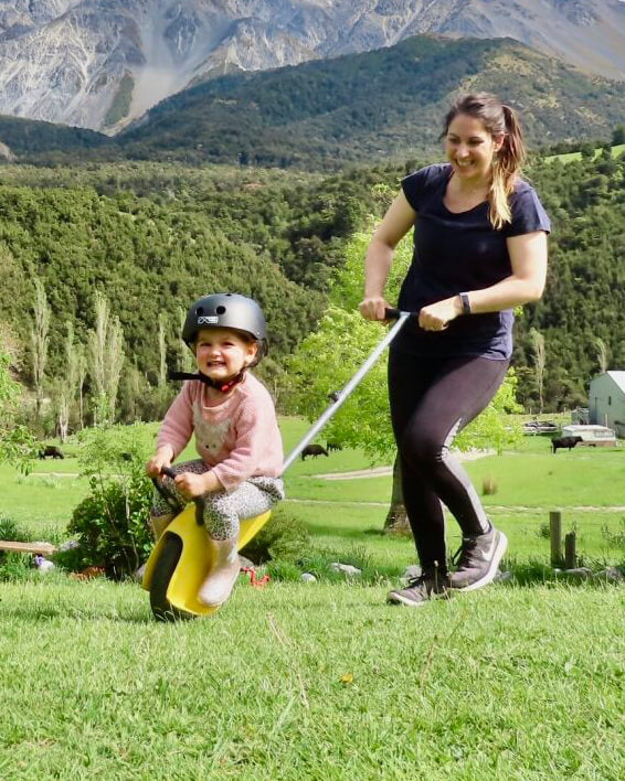Female pushing happy child riding the unirider™ single wheeled fun rider - Mountain Buggy Riders