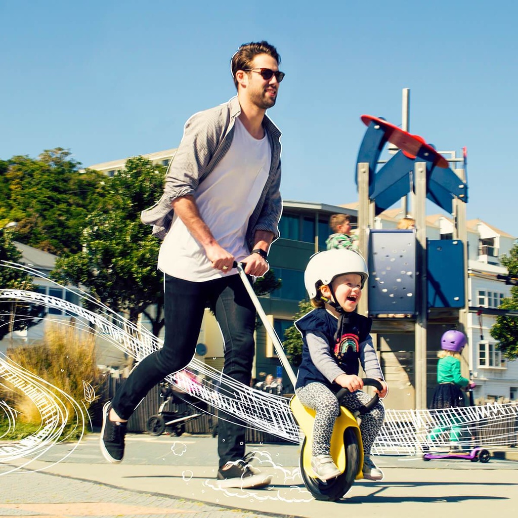 Mountain Buggy unirider with dad pushing his daughter in the park_yellow